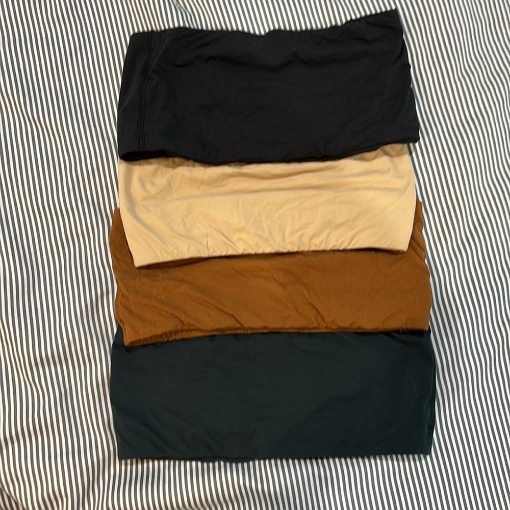 Set of four skims strapless bandeau bralettes in neutrals . Size m